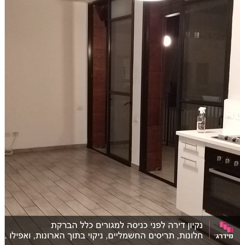 בקבוק תרסיס ניקוי ומטלית על השיש במטבח